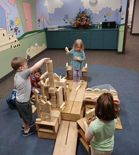 children playing with wooden building blocks